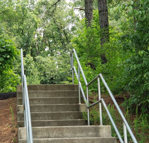 zigzagged metal railings over 
cement stairs going up to Schrom Hills Park